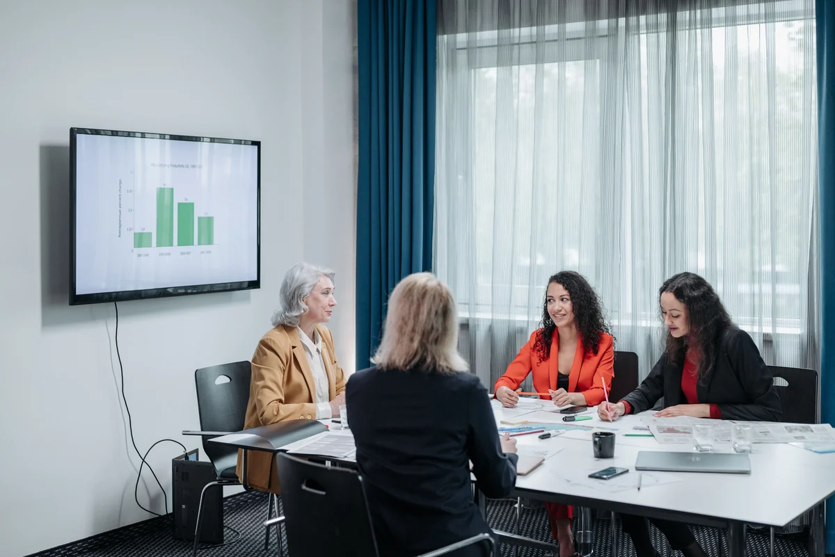A group of business professionals collaborating around a meeting table